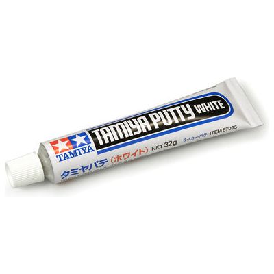 The currently available Tamiya Putty (Basic Type) has long been praised by modellers for its high quality and ease of use. However, it's gray color sometimes made painting over it with a lighter color difficult. Tamiya now provides modellers with a white-colored putty to solve this problem. Useful for filling holes and seam lines, this versatile putty can be used on plastic, wood, or metal, and can also be diluted with lacquer thinner for a wide range of applications. Each aluminum tube contains 32 grams (1