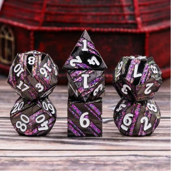 The perfect companion for your gaming needs! These premium die-cast polyhedral dice are exactly what you've been searching for that upcoming game night with the group. Each set weighs roughly 5 ounces and are stored in a quality, brushed metal tin with foam insert. These dice are engraved with crisp, easy-to-read numerals. Many styles and colors are available.

This set includes one of each: d20, d12, d10, d10 (percentile), d8, d6, and a d4 (7 dice in total). All inside a premium Dice Tin.