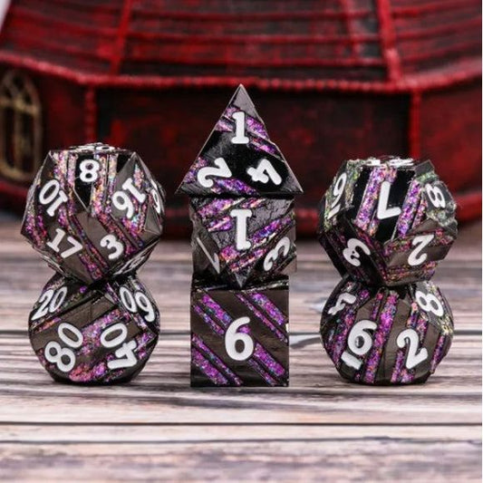 The perfect companion for your gaming needs! These premium die-cast polyhedral dice are exactly what you've been searching for that upcoming game night with the group. Each set weighs roughly 5 ounces and are stored in a quality, brushed metal tin with foam insert. These dice are engraved with crisp, easy-to-read numerals. Many styles and colors are available.

This set includes one of each: d20, d12, d10, d10 (percentile), d8, d6, and a d4 (7 dice in total). All inside a premium Dice Tin.